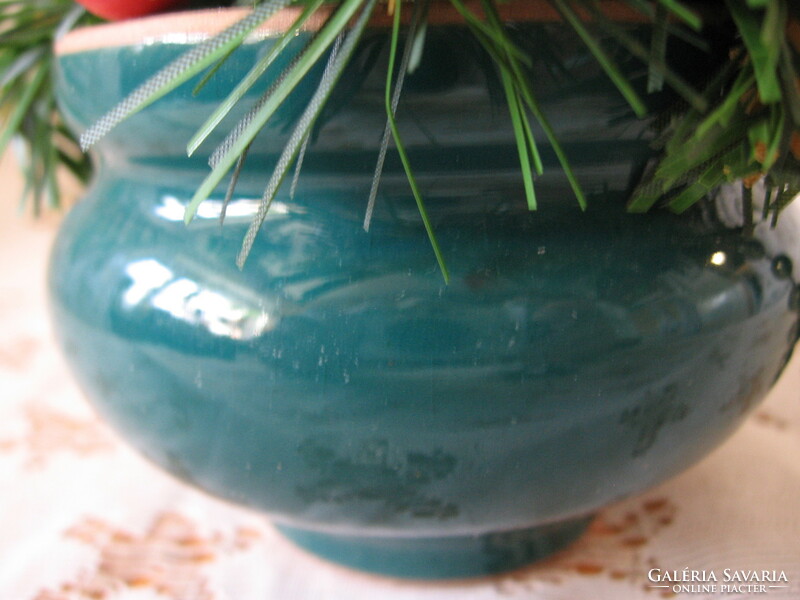 Christmas table decoration in a green ceramic pot
