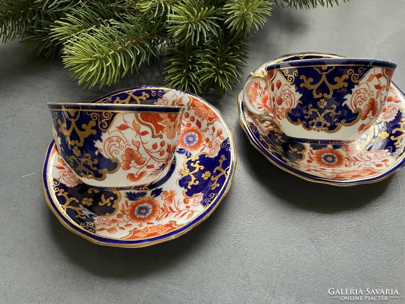 Pair of hand-painted Imari pattern royal crown derby porcelain cups and small plates