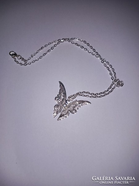 Silver colored (new) butterfly pendant necklace.