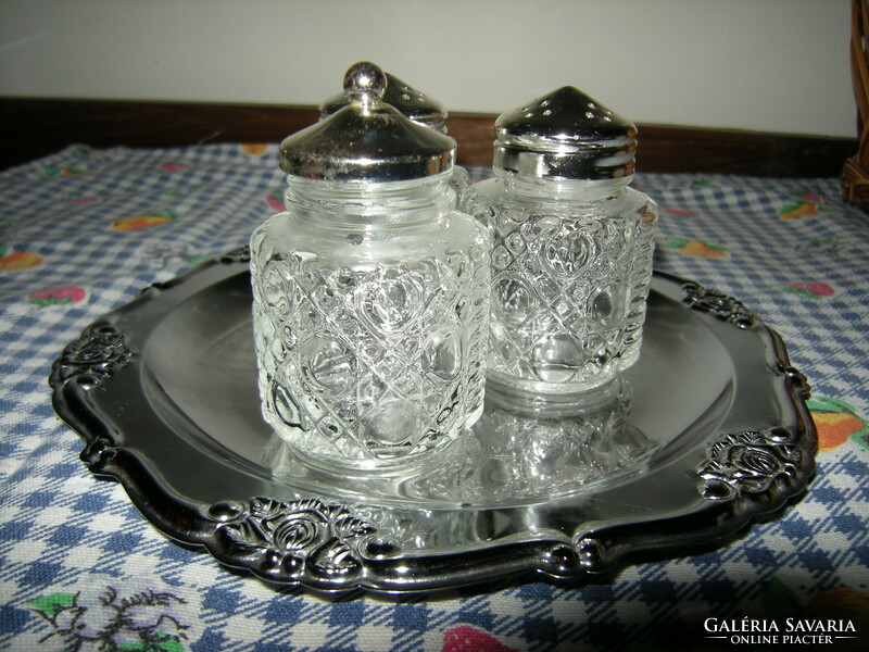 Salt and pepper shakers on 3 stainless steel trays