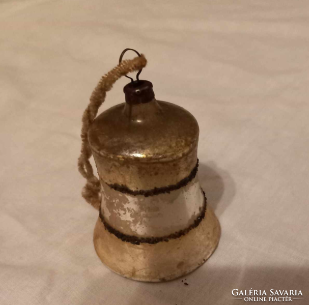 A very old bell-shaped Christmas tree ornament may once have been silver-gold