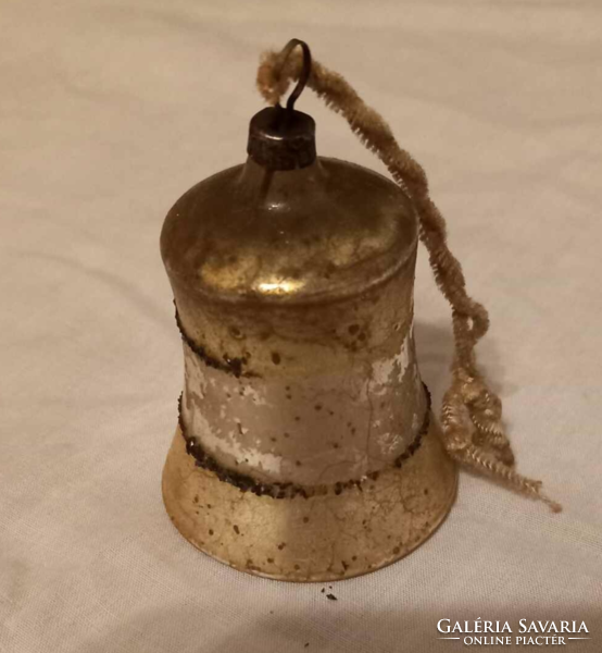 A very old bell-shaped Christmas tree ornament may once have been silver-gold