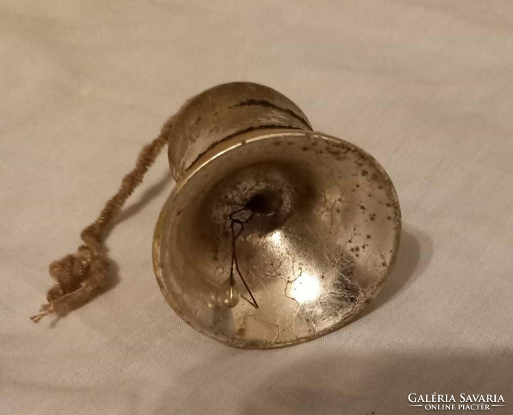 A very old bell-shaped Christmas tree ornament may once have been silver-gold