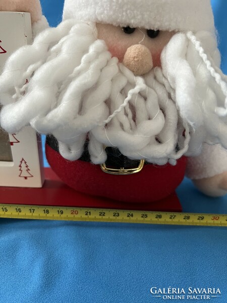 Santa Claus, with a wooden photo frame on a stand