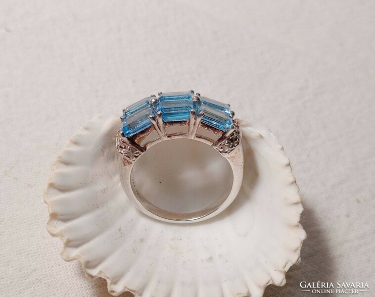 Old art deco style silver ring with blue topaz stones.