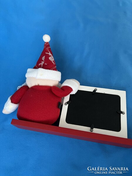 Santa Claus, with a wooden photo frame on a stand