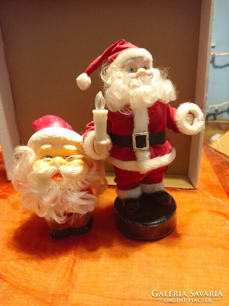 Two retro Santa Clauses, one with a musical instrument and one with a rubber head