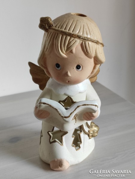 The singing ceramic candle holder and the plastic angel face disguised as devout marble are a pair
