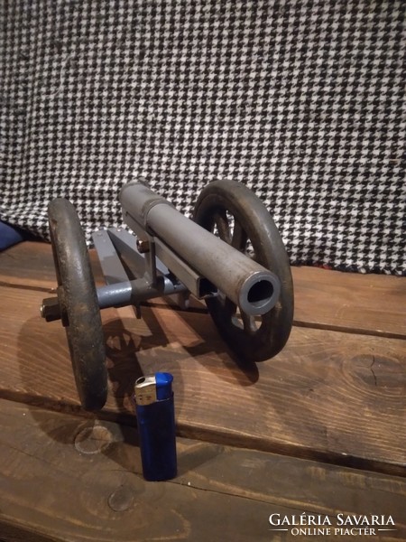 Large cannon, gun, old cast iron rammer on rubber wheels, the cannon is made of iron, with welding..