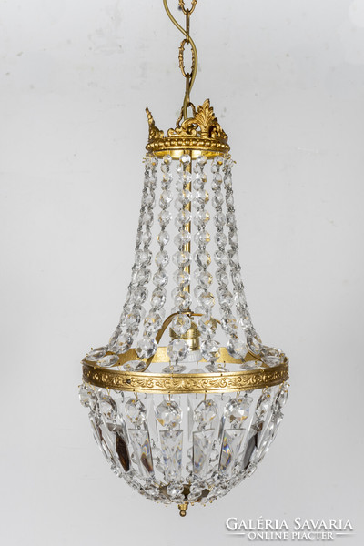 A small ampoule-shaped crystal chandelier with a gilded frame