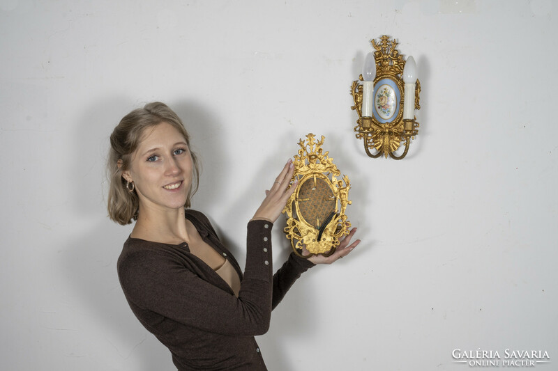 Neo-baroque gilded wall arm paired with porcelain insert