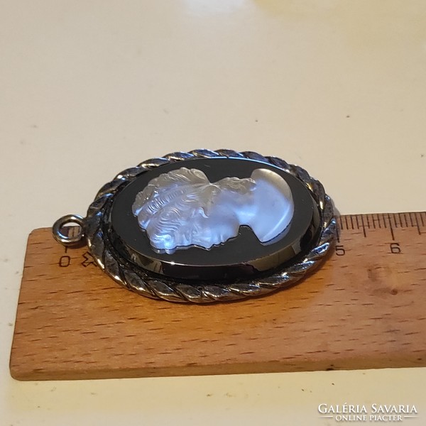 Used glass cameo pendant in a metal frame in good condition