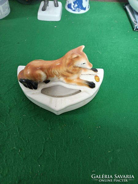 Porcelain sitting dog for sale.