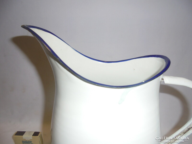 Old snow-white enameled wash basin, enameled jug 
