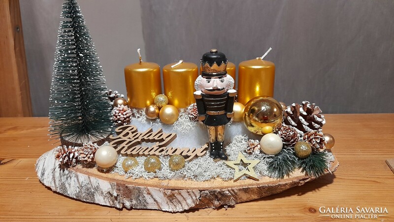 Advent decoration with a nutcracker figure in golden color on a wooden base