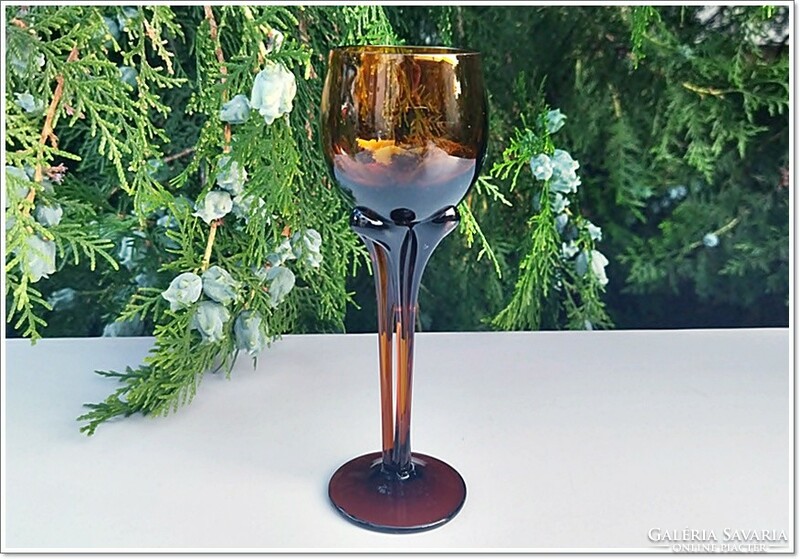 Special, artistic, amber-colored short drink, bitter liqueur stemmed glass goblet, glass