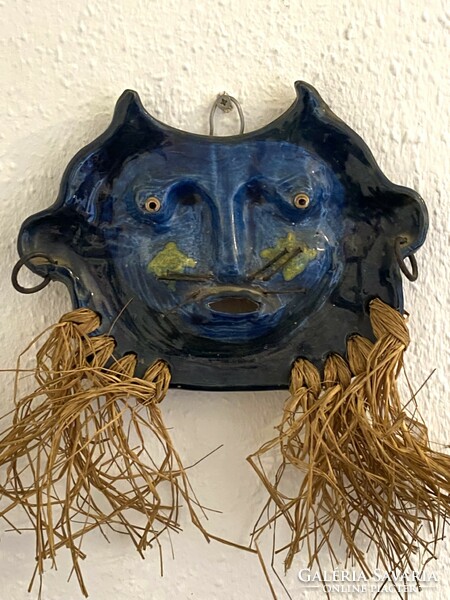 Painted ceramic wall mask with a mustache made of iron nails and a bushy beard
