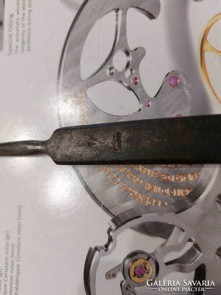 (K) some old medical tool with a blacksmith's mark