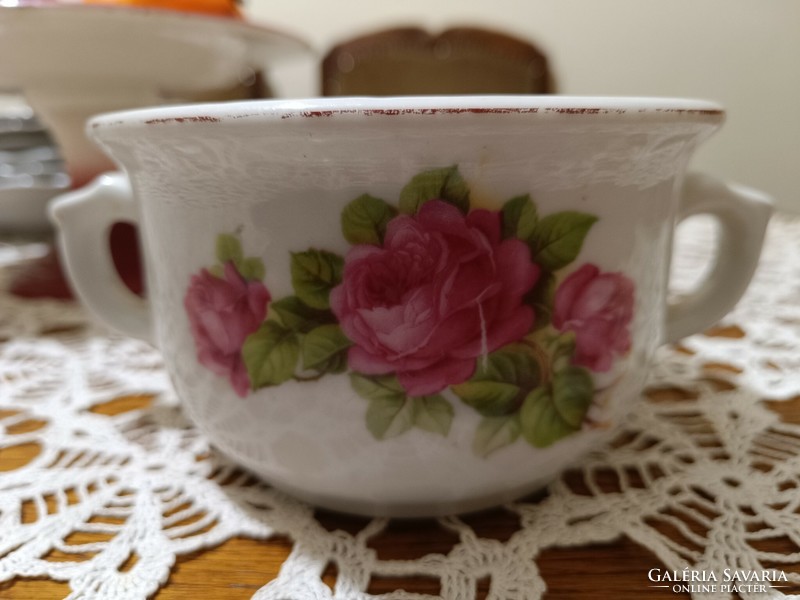 Antique coma cup with a bouquet of roses