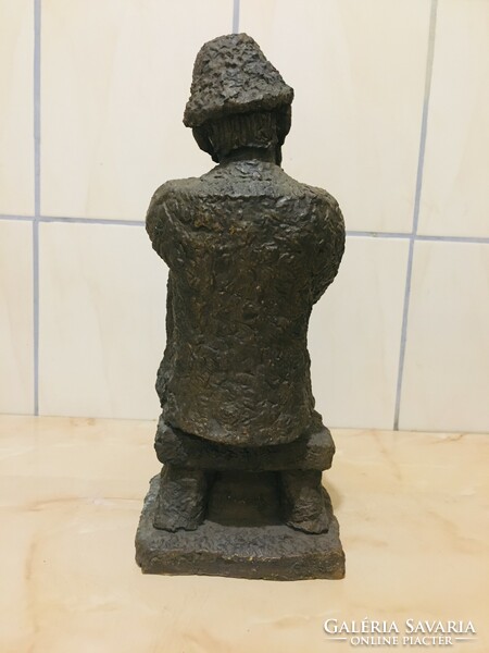 Large ceramic statue of a resting shepherd