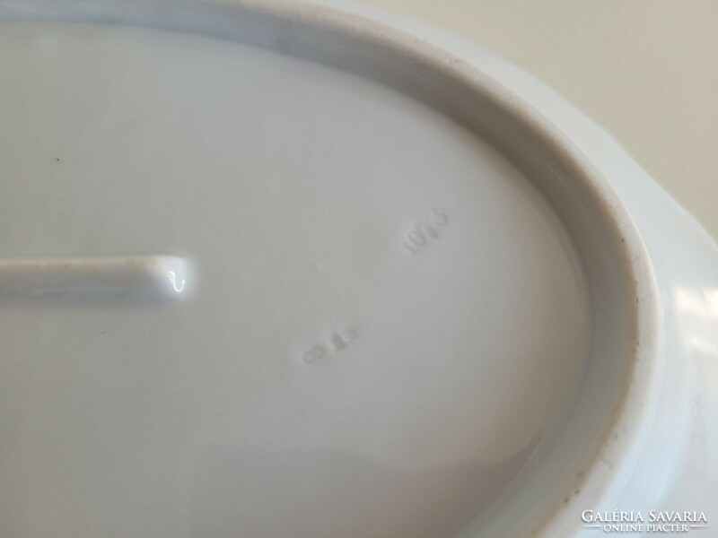 Old white porcelain serving oval bowl with a handle