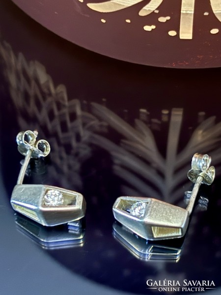 A pair of silver earrings in art-deco style with zirconia stones