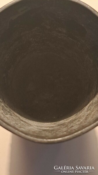 On the side of an antique pewter cup are scenes from Wagner's Walküre