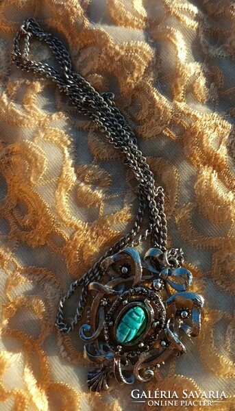 Hanging with a special pendant with a scarab stone in the middle