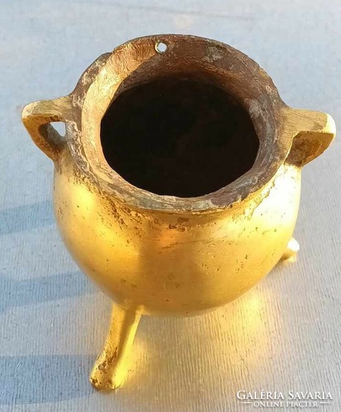 Antique thick-walled bronze three-legged vessel