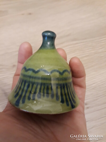 New, green glazed Christmas bell made of earthenware
