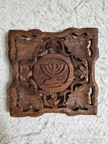 Carved wooden table decoration depicting a menorah, placemat