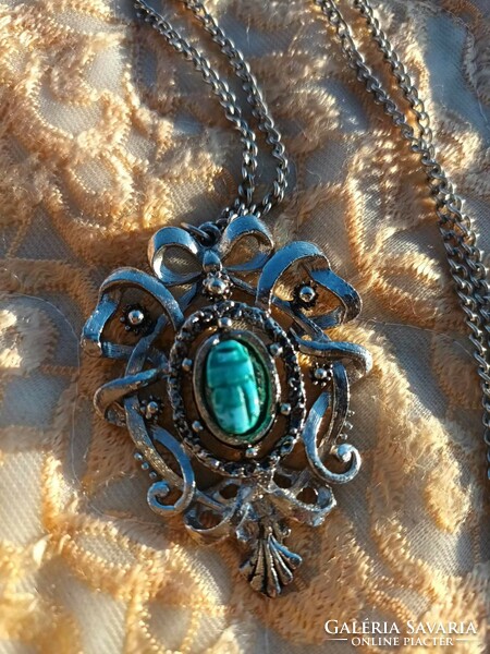 Hanging with a special pendant with a scarab stone in the middle