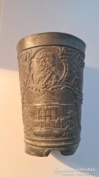 On the side of an antique pewter cup are scenes from Wagner's Walküre
