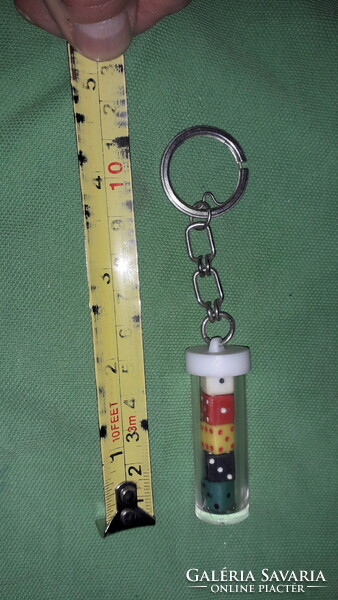 Retro traffic plastic cylinder with small plastic colored dice inside, key holder according to the pictures 1.