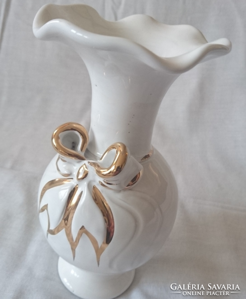 White vase with golden bow