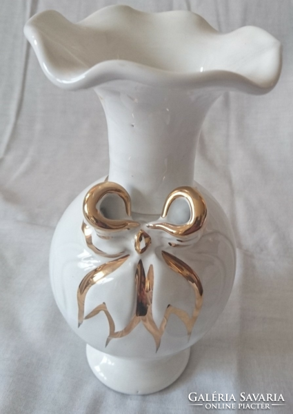 White vase with golden bow