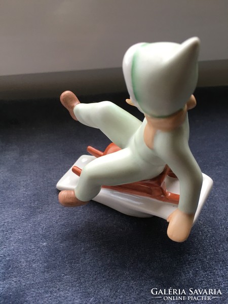 Little girl sledding - old porcelain figure from Aquincum