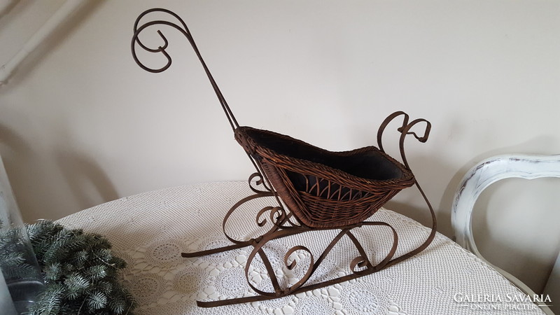 Antique wrought iron and wicker baby sled, decoration