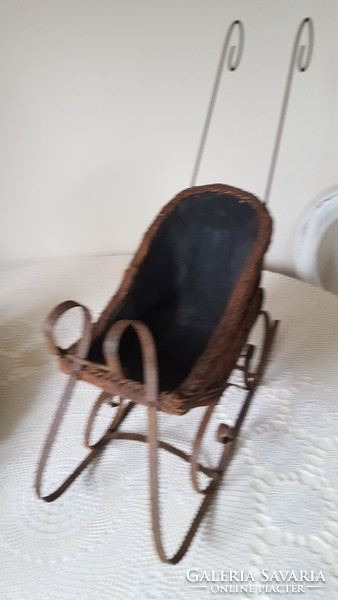Antique wrought iron and wicker baby sled, decoration