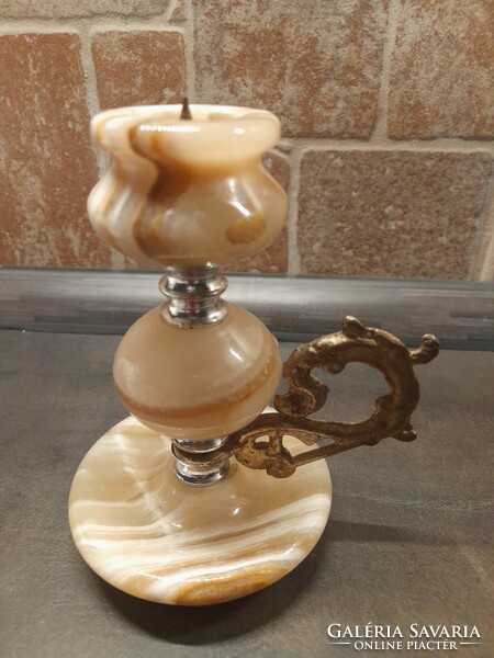 Candle holder made of decorative stone. With a copper-colored ear. Candle holder with spike