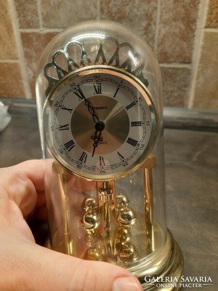 Staiger quartz clock rotating pendulum, gold colored clock. It works