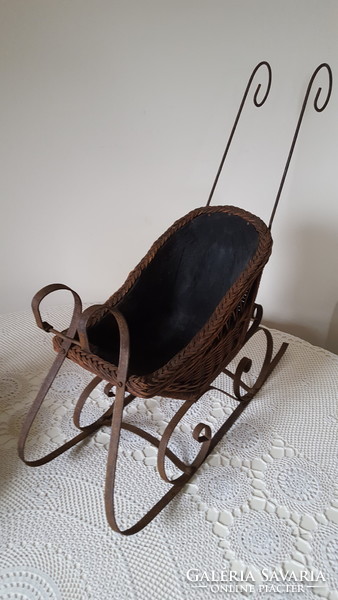 Antique wrought iron and wicker baby sled, decoration