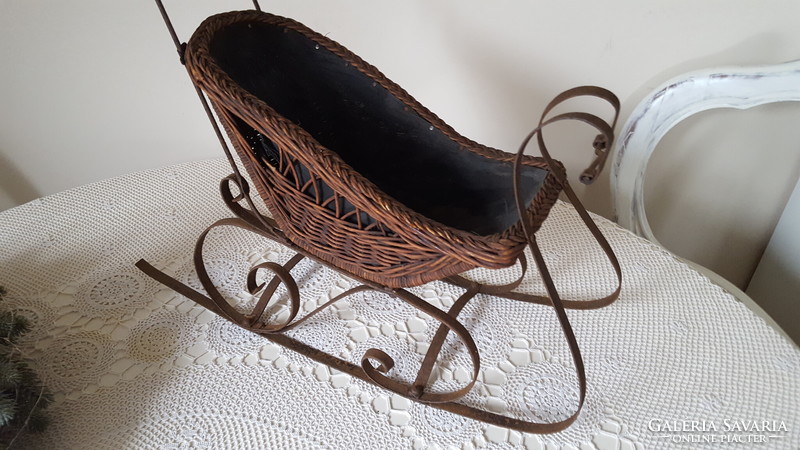 Antique wrought iron and wicker baby sled, decoration