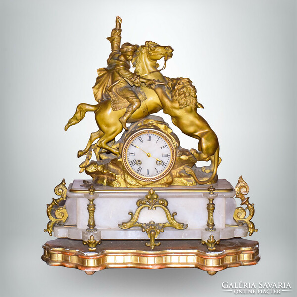 French half-baked fireplace clock, stone case decorated with a gilded statue on a wooden plinth
