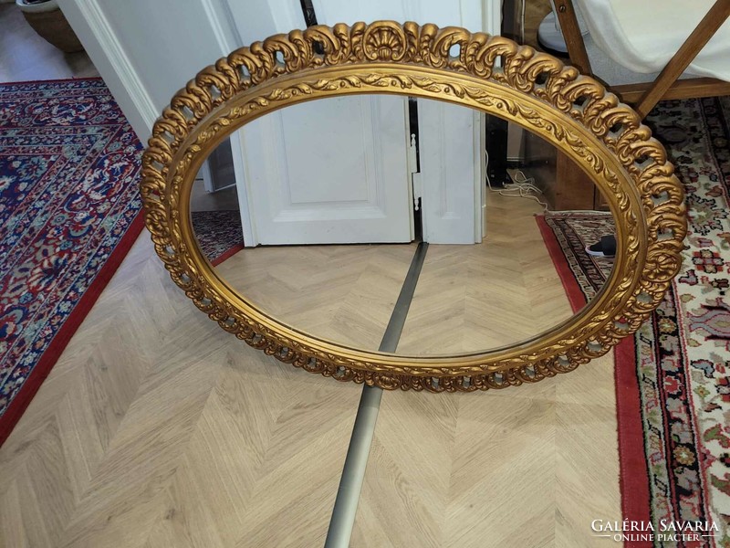 Oval mirror with a beautiful golden frame