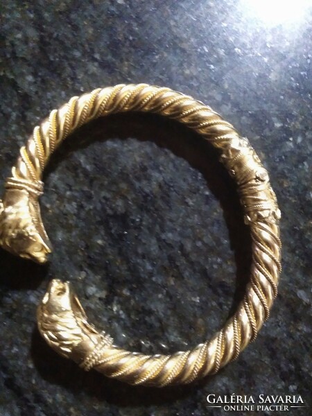 A special gold bracelet with a dragon's head, cuffs.