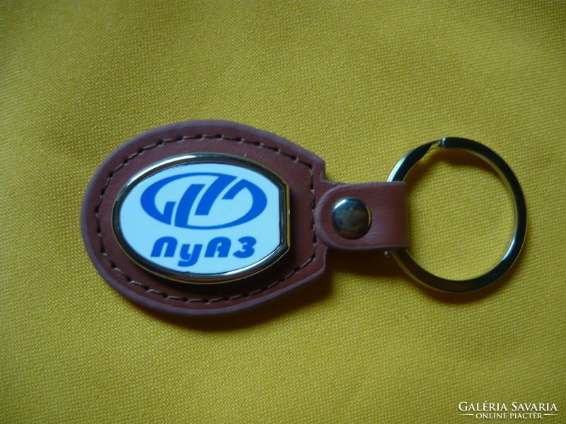 Luaz oval metal keychain on a leather background