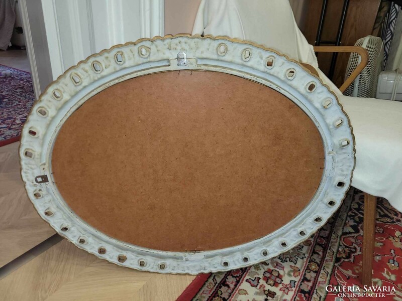 Oval mirror with a beautiful golden frame