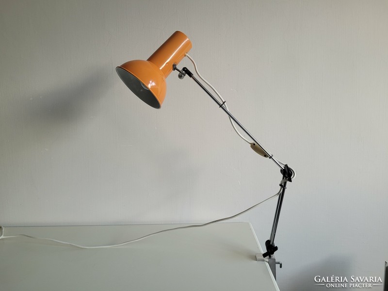 Orange colored old retro long arm adjustable desk lamp mid century