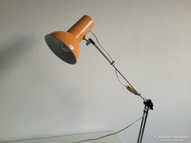 Orange colored old retro long arm adjustable desk lamp mid century